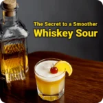 A whiskey sour cocktail with a bottle of liquor on the side, highlighting the secret to a smoother whiskey sour.