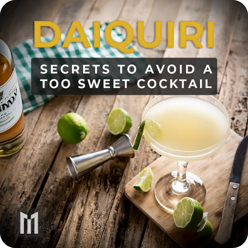 Balanced Daiquiri in coupe glass with lime, jigger, and white rum bottle on a rustic wooden table.