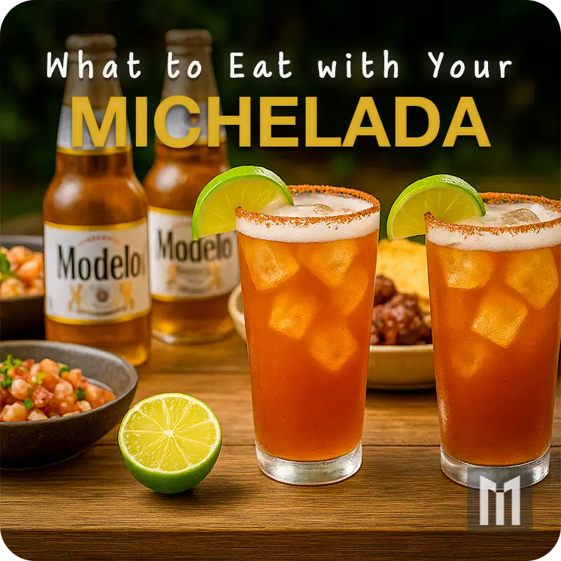 Two Micheladas in pint glasses with lime and chili rims next to tacos chips and cold beer bottles.